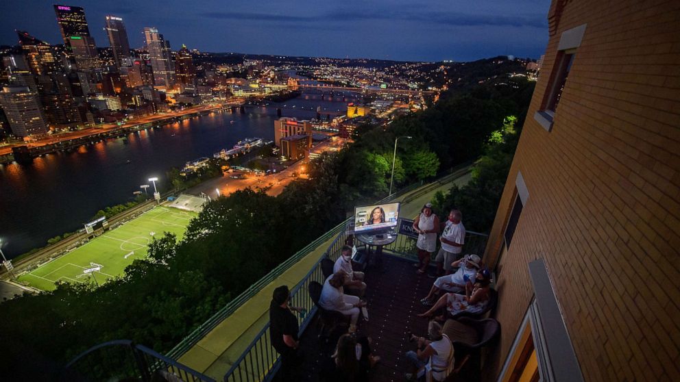 PHOTO: Guests watch television coverage of the 2020 Democratic National Convention at a DNC watch party overlooking the city of Pittsburgh, Aug. 18, 2020.