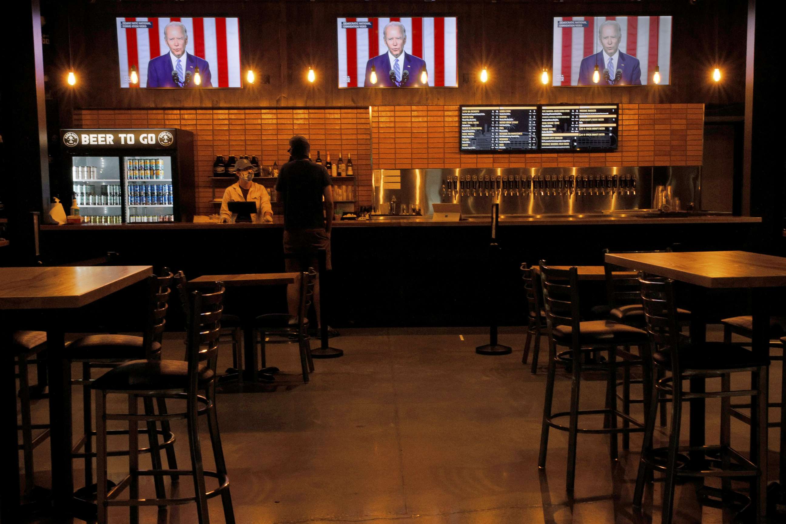 PHOTO: Televisions at Good City Brewing show footage of Democratic presidential nominee Joe Biden during the Democratic National Convention in Milwaukee, Aug. 19, 2020.