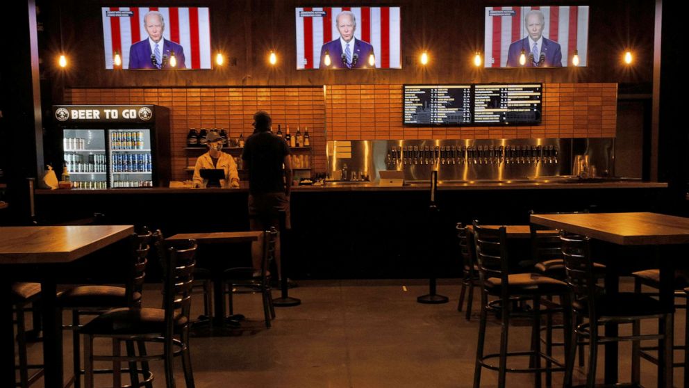 PHOTO: Televisions at Good City Brewing show footage of Democratic presidential nominee Joe Biden during the Democratic National Convention in Milwaukee, Aug. 19, 2020.