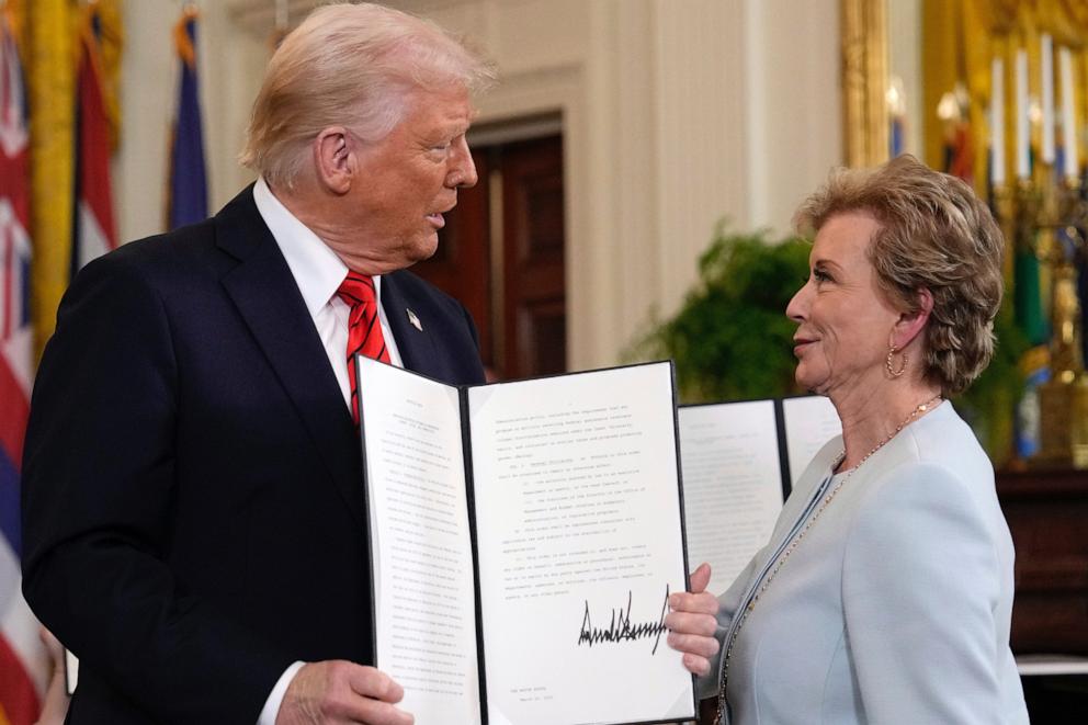 PHOTO: President Donald Trump holds up a signed executive order alongside Secretary of Education Linda McMahon in the East Room of the White House in Washington, Thursday, March 20, 2025.