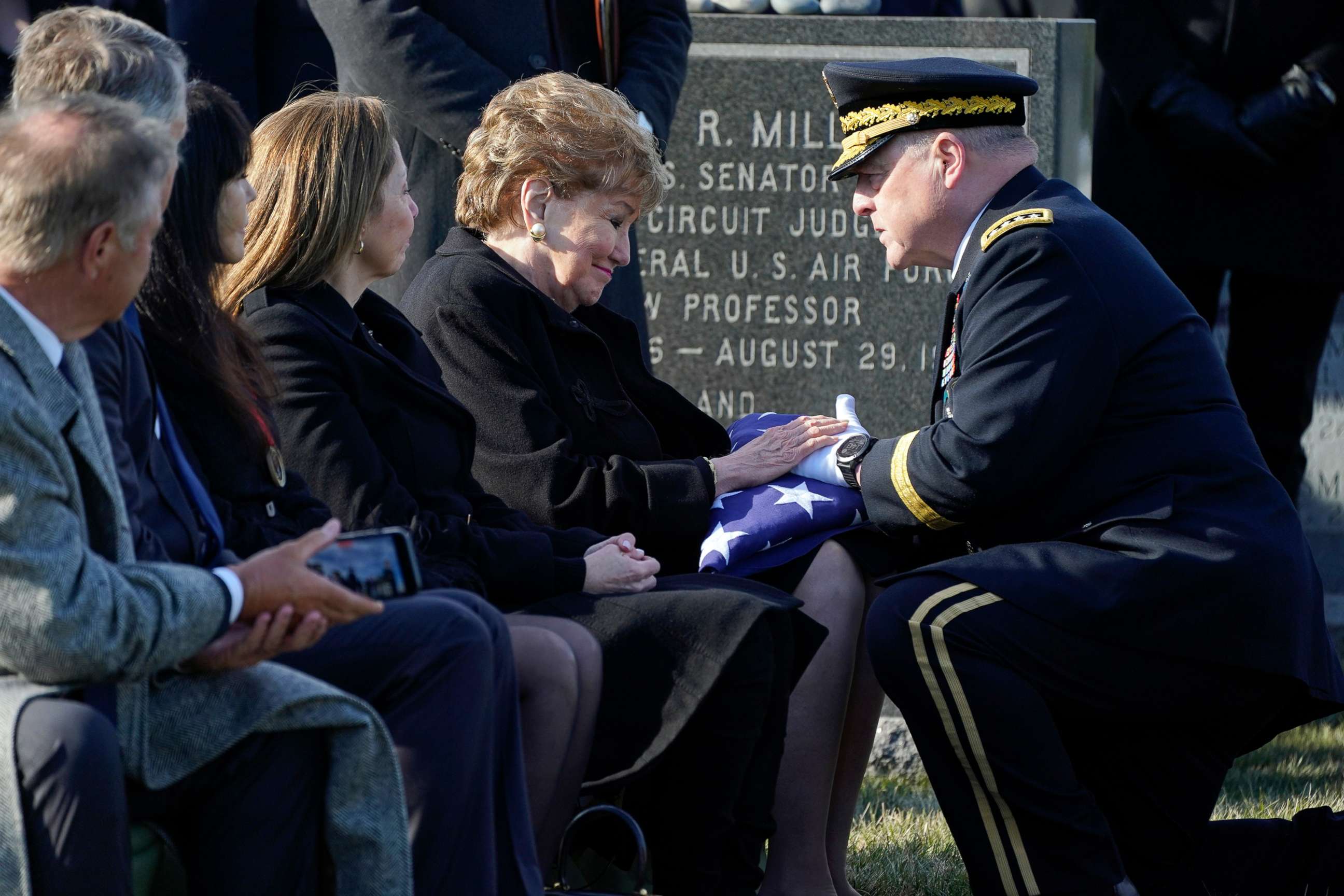 PHOTO: Chairman of the Joint Chiefs of Staff Gen. Mark Milley gives former Sen. Elizabeth Dole, a folded U.S. flag during the burial service for her late husband Bob Dole, at Arlington National Cemetery in Arlington, Va., Feb. 2, 2022.