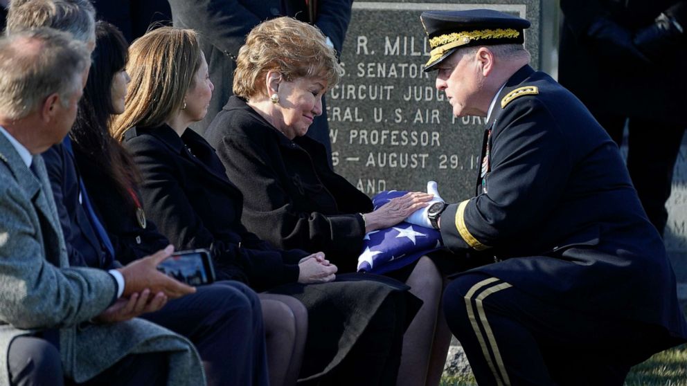 PHOTO: Chairman of the Joint Chiefs of Staff Gen. Mark Milley gives former Sen. Elizabeth Dole, a folded U.S. flag during the burial service for her late husband Bob Dole, at Arlington National Cemetery in Arlington, Va., Feb. 2, 2022.