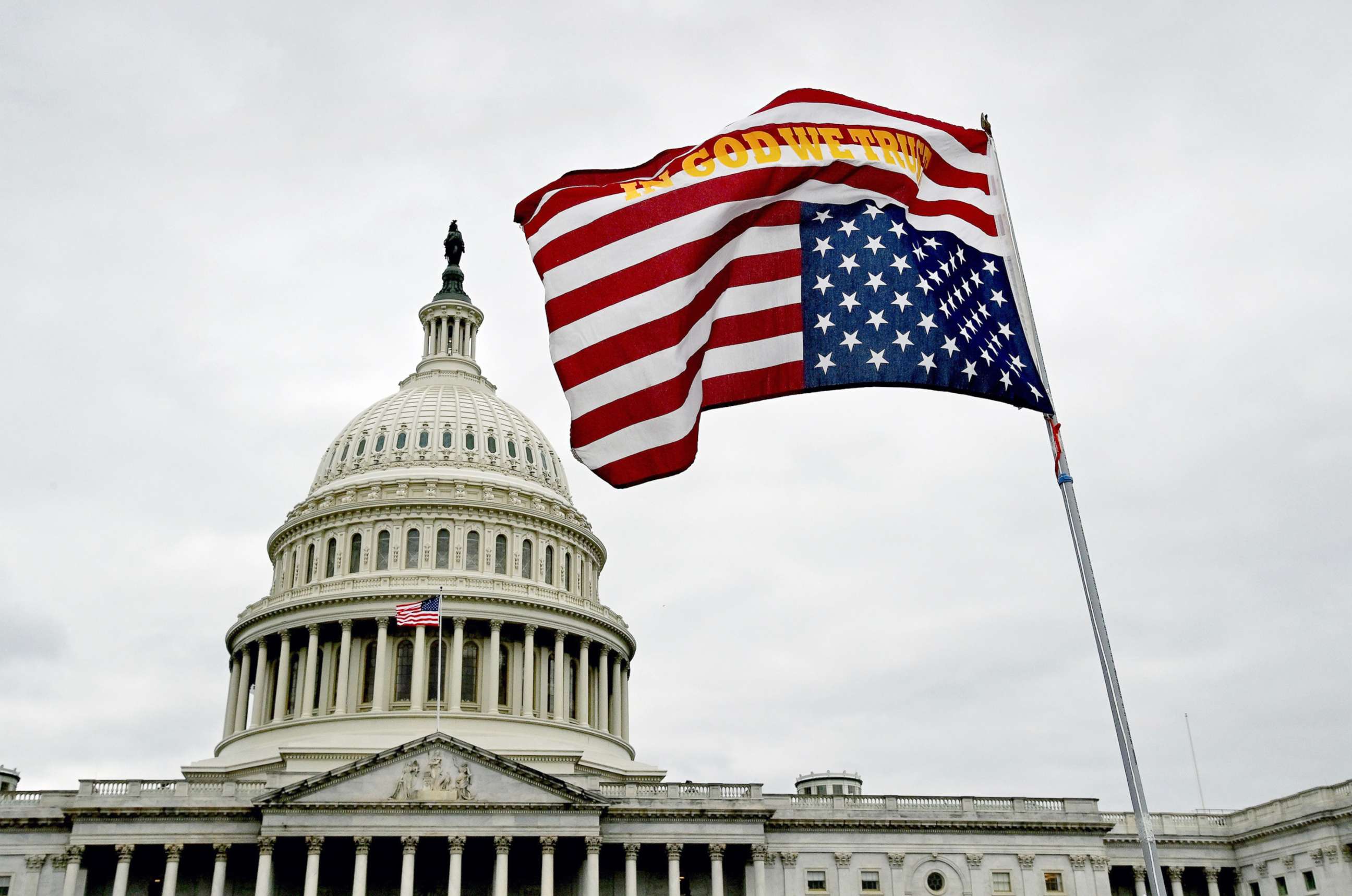 PHOTO: A flag waves upside down in front of the U.S. Capitol grounds in Washington, D.C. on Jan. 06, 2021. 