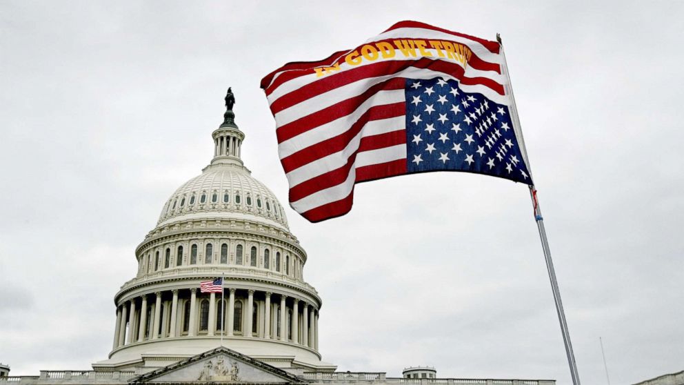 PHOTO: A flag waves upside down in front of the U.S. Capitol grounds in Washington, D.C. on Jan. 06, 2021. 