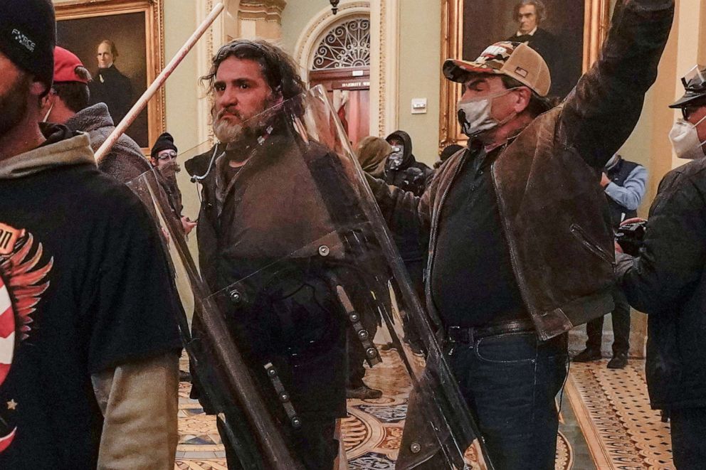 PHOTO: In this Jan. 6, 2021 photo, rioters, including Dominic Pezzola, center with police shield, are confronted by Capitol Police officers outside the Senate Chamber inside the Capitol, Jan. 6, 2021, in Washington.