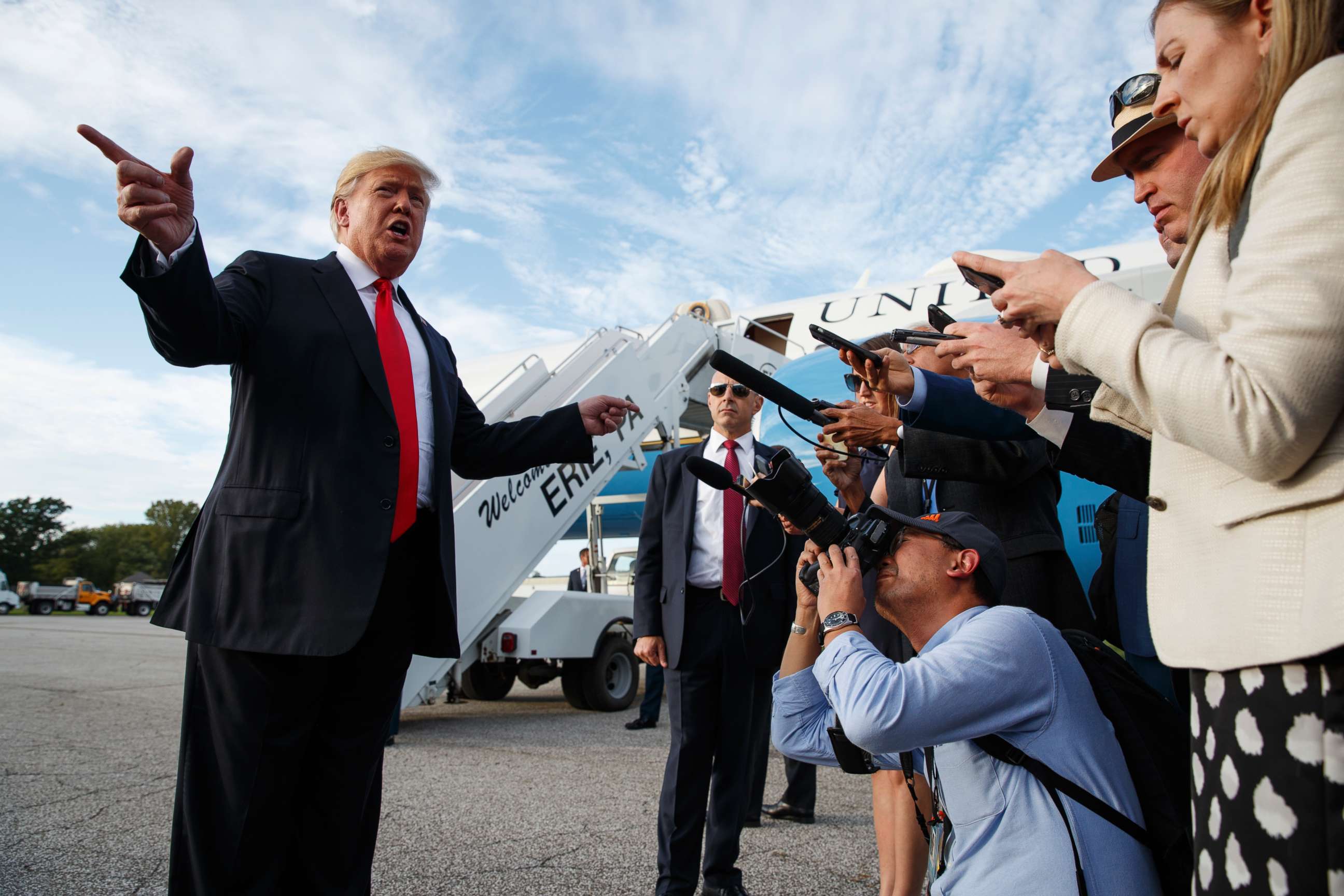 PHOTO: President Donald Trump talks with reporters after arriving at Erie International Airport for a campaign rally at Erie Insurance Arena, Oct. 10, 2018, in Erie, Pa.