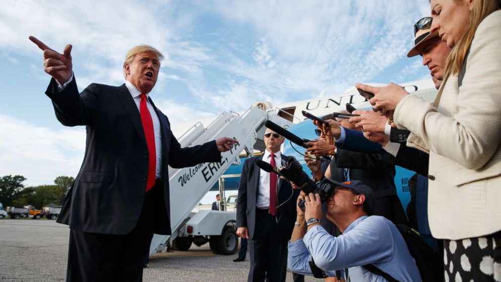 PHOTO: President Donald Trump talks with reporters after arriving at Erie International Airport for a campaign rally at Erie Insurance Arena, Oct. 10, 2018, in Erie, Pa.