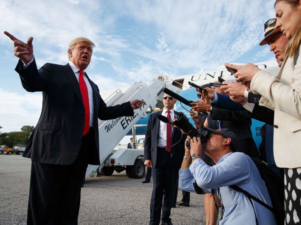 PHOTO: President Donald Trump talks with reporters after arriving at Erie International Airport for a campaign rally at Erie Insurance Arena, Oct. 10, 2018, in Erie, Pa.