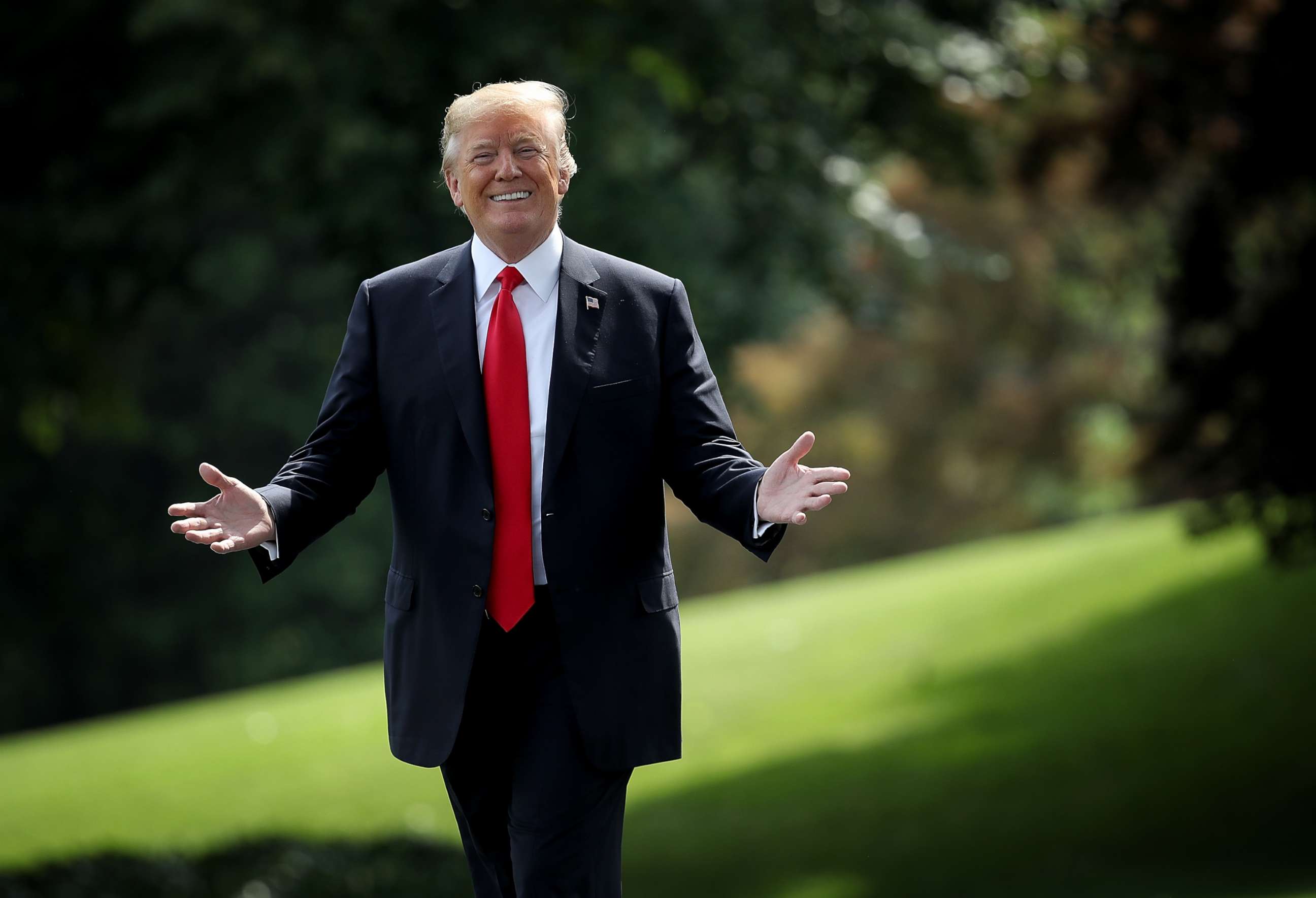 PHOTO: U.S. President Donald Trump gestures toward journalists shouting questions as he departs the White House, May 29, 2018, in Washington.