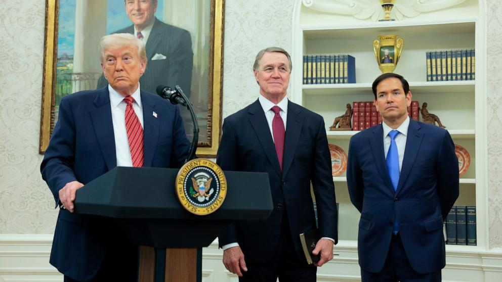 PHOTO: President Donald Trump speaks during a swearing-in ceremony for new U.S. Ambassador to China David Perdue, as Secretary of State Marco Rubio, looks on in the Oval Office at the White House on May 07, 2025 in Washington, DC.
