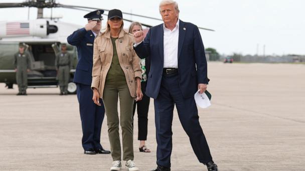 Donald Trump gestures alongside Melania Trump, as they arrive on Air Force One at Kelly Field air base in San Antonio, Texas, en route to observe flood damage in Kerrville, Texas, July 11, 2025.