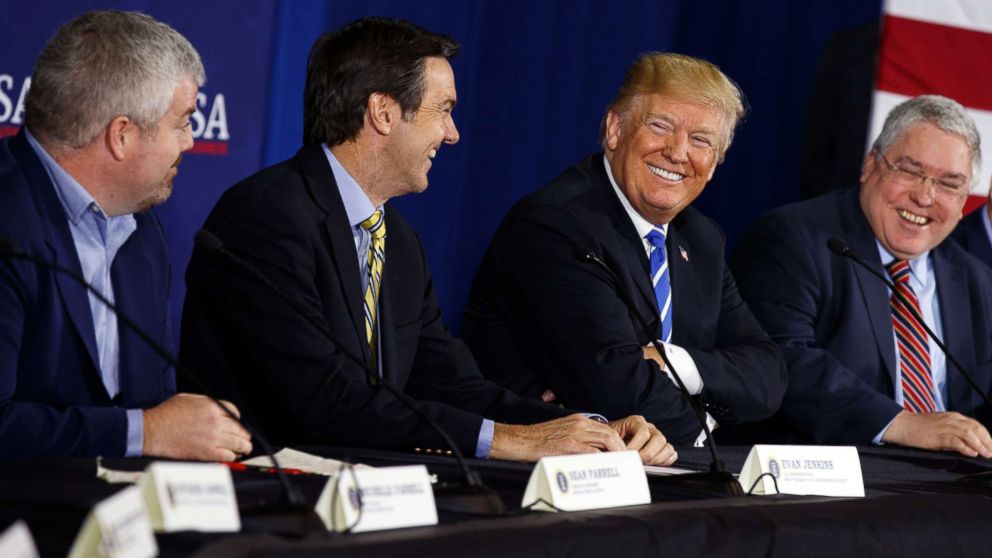 President Donald Trump smiles during a roundtable discussion on tax policy, April 5, 2018, in White Sulphur Springs, W.Va., with from left, Service Pump and Supply principal engineer Sean Farrell, Rep. Evan Jenkins, R-W.Va., and West Virginia Attorney General Patrick Morrisey.