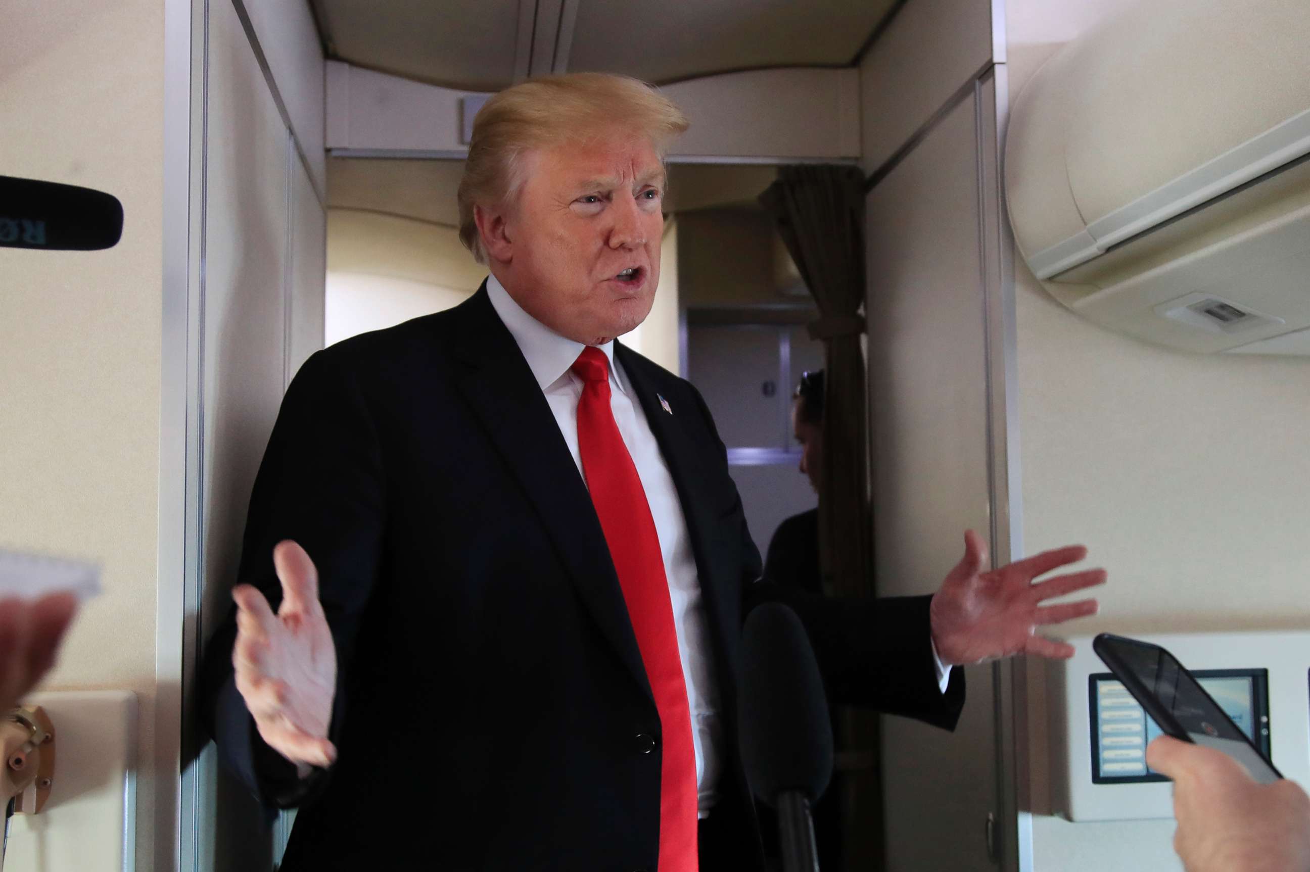 PHOTO: President Donald Trump speaks to reporters on board Air Force One, June 29, 2018, on his way to Bedminster, N.J.