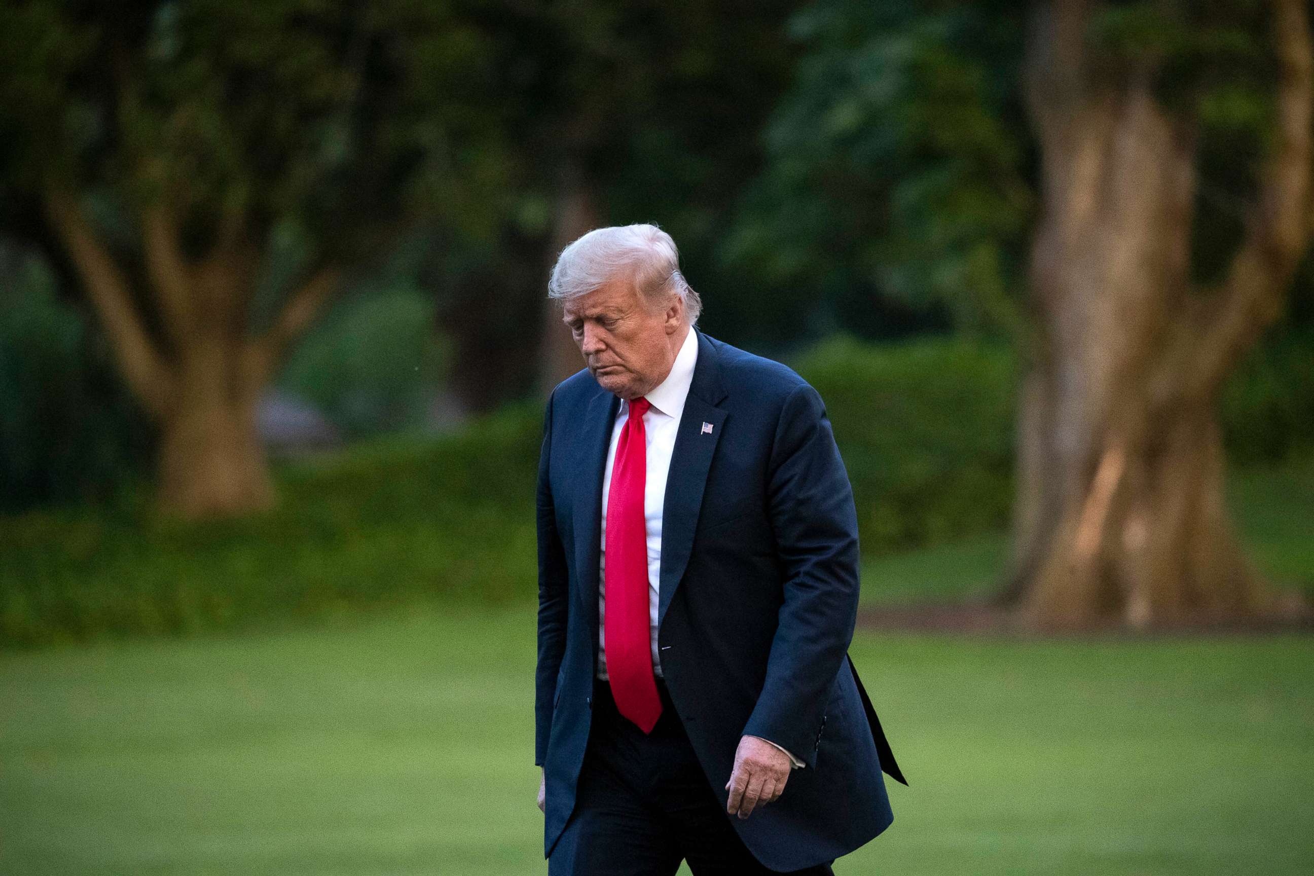 PHOTO: President Donald Trump walks on he South Lawn after arriving on Marine One at the White House, June 25, 2020.