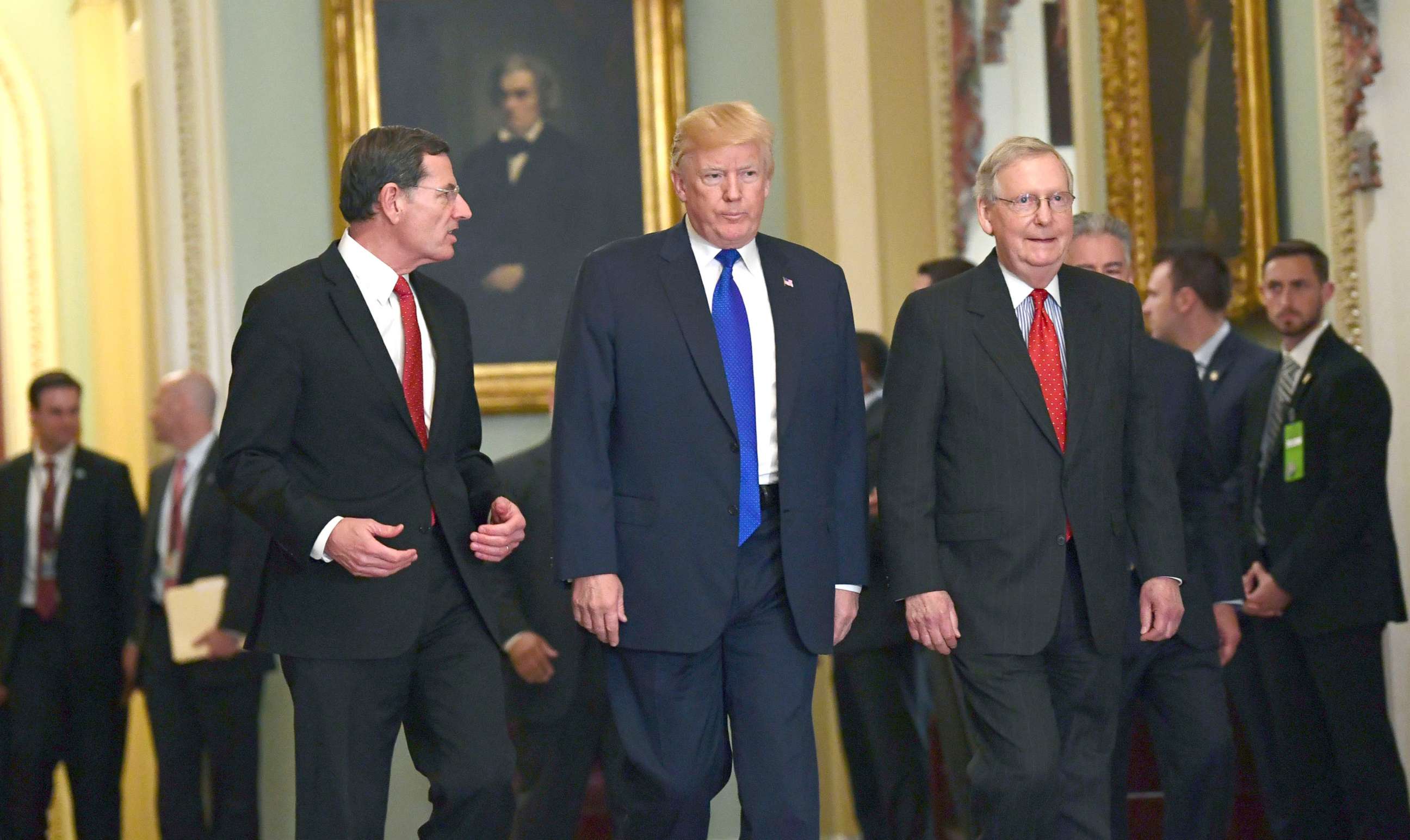 PHOTO: President Donald Trump, walks with Sen. John Barrasso, left, and Senate Majority Leader Mitch McConnell, right, as he arrives on Capitol Hill in Washington, Nov. 28, 2017. 