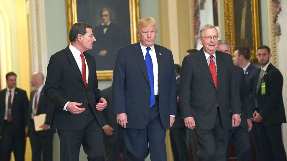 PHOTO: President Donald Trump, walks with Sen. John Barrasso, left, and Senate Majority Leader Mitch McConnell, right, as he arrives on Capitol Hill in Washington, Nov. 28, 2017.