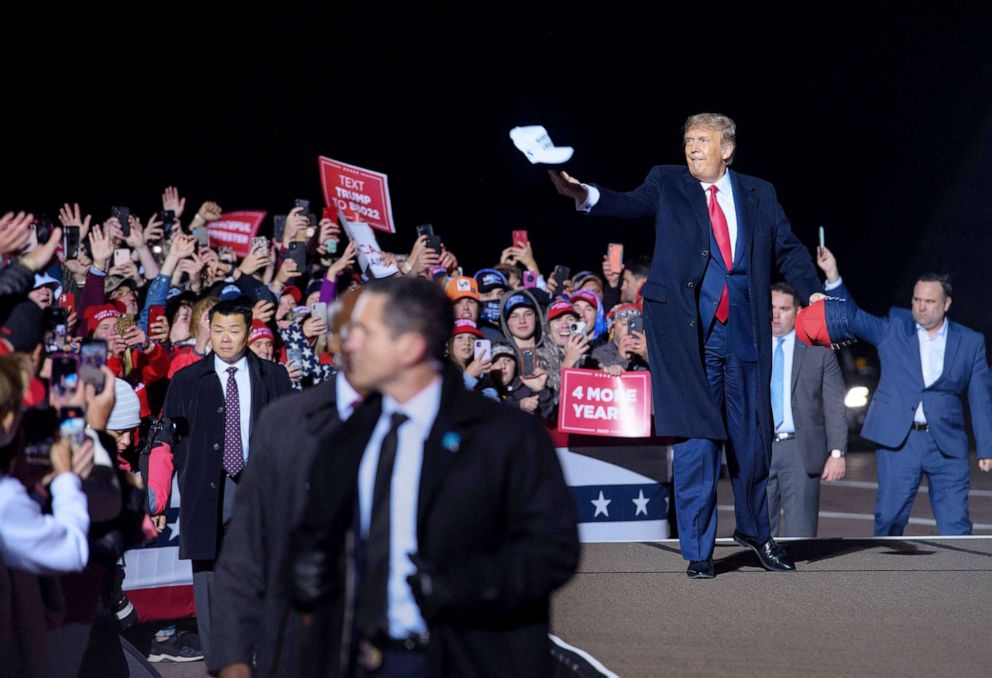 PHOTO: President Donald Trump tosses a cap to supporters as he arrives for a campaign rally at Duluth International Airport in Duluth, Minnesota on Sept. 30, 2020. 