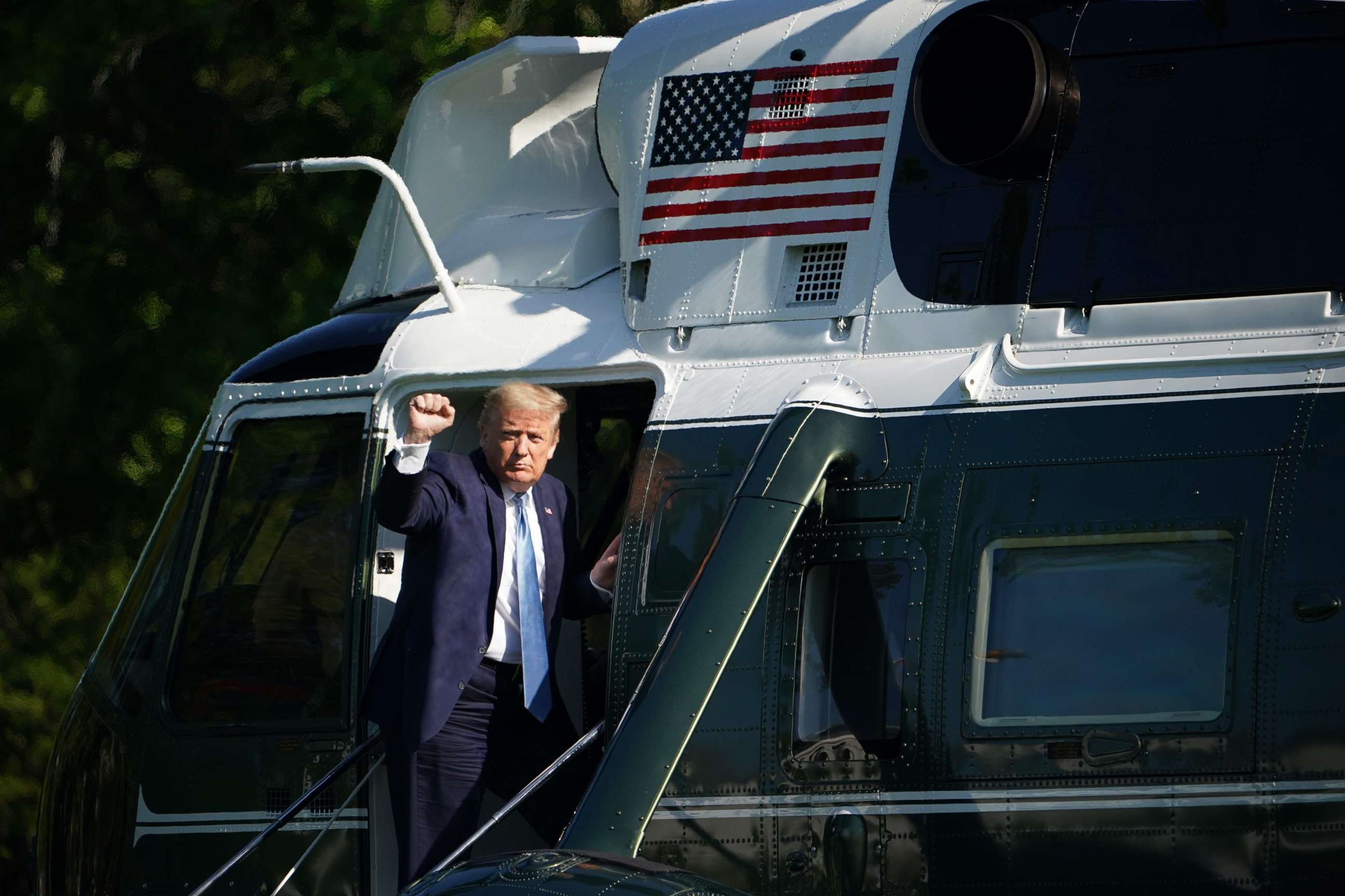 PHOTO: President Donald Trump makes makes a fist as he boards Marine One before departing from the South Lawn of the White House in Washington, May 15, 2020.