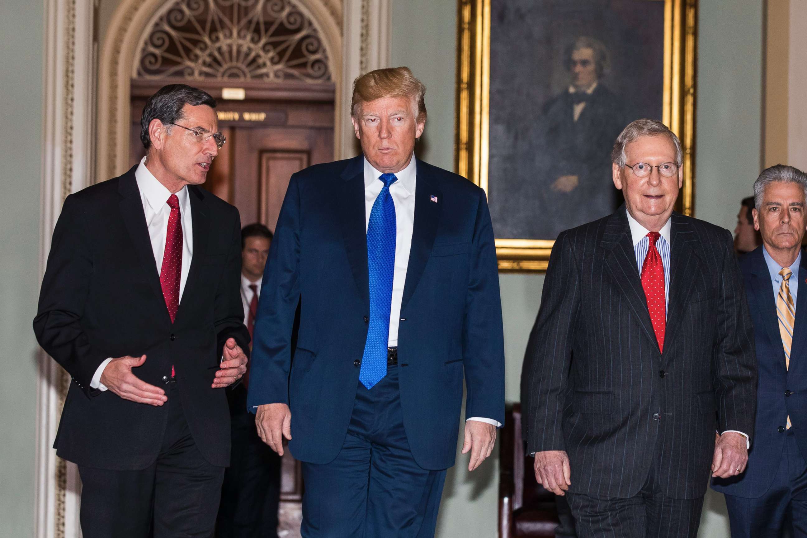 PHOTO: President Donald Trump along with Republican Senator from Wyoming John Barrasso (L) and Republican Senate Majority Leader from Kentucky Mitch McConnell (R), walk to a Republican Senate luncheon in the U.S. Capitol on Nov. 28 2017.