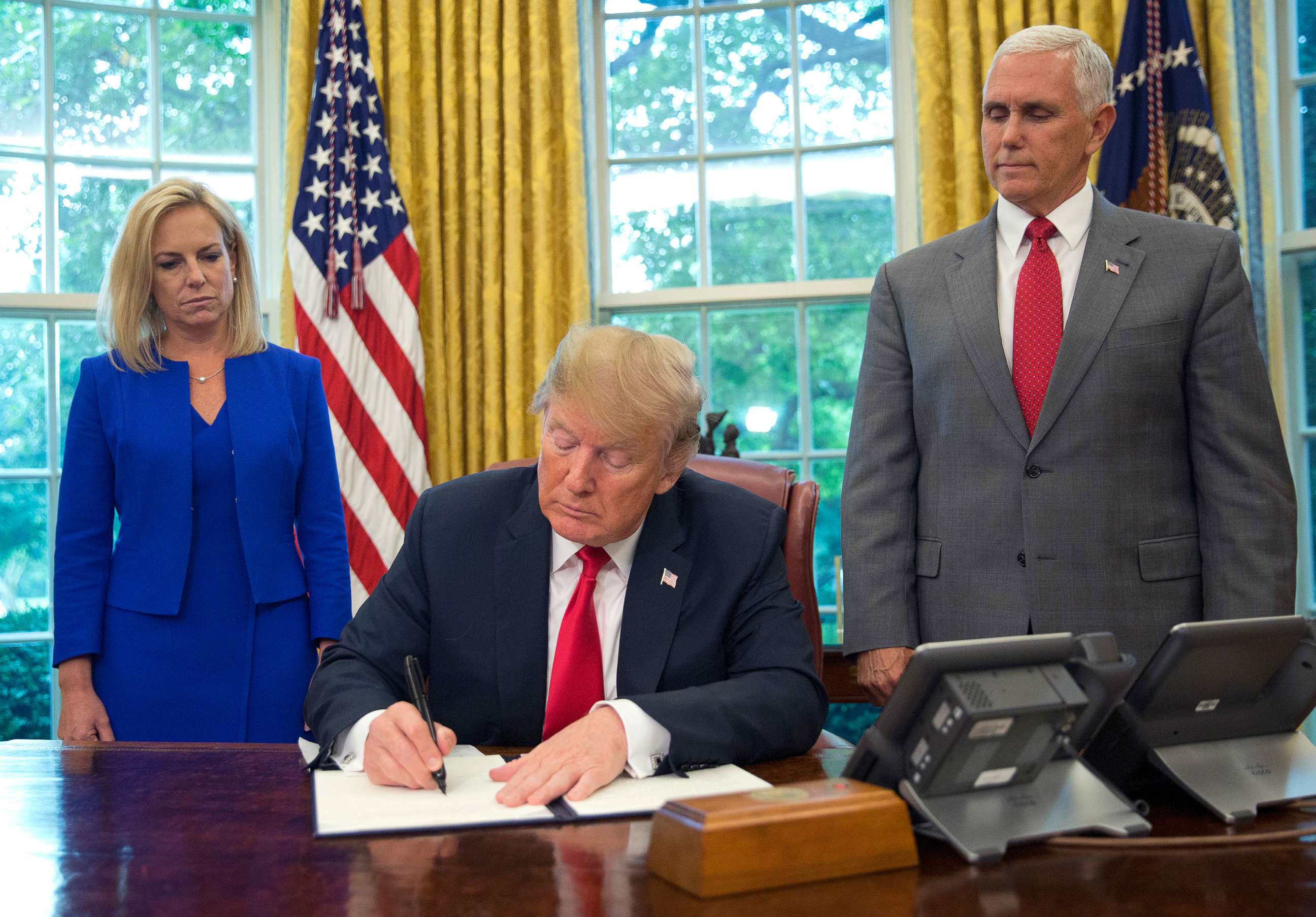 PHOTO: President Donald Trump signs an executive order to keep families together at the border during an event in the Oval Office of the White House in Washington, Wednesday, June 20, 2018.