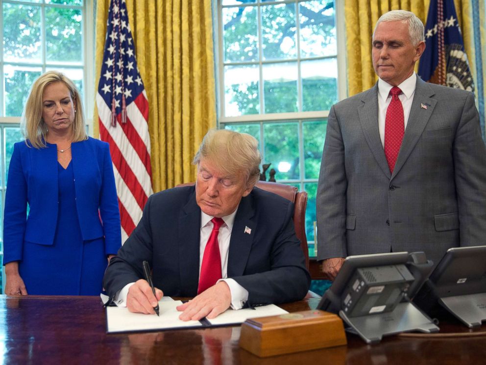 PHOTO: President Donald Trump signs an executive order to keep families together at the border during an event in the Oval Office of the White House in Washington, June 20, 2018.