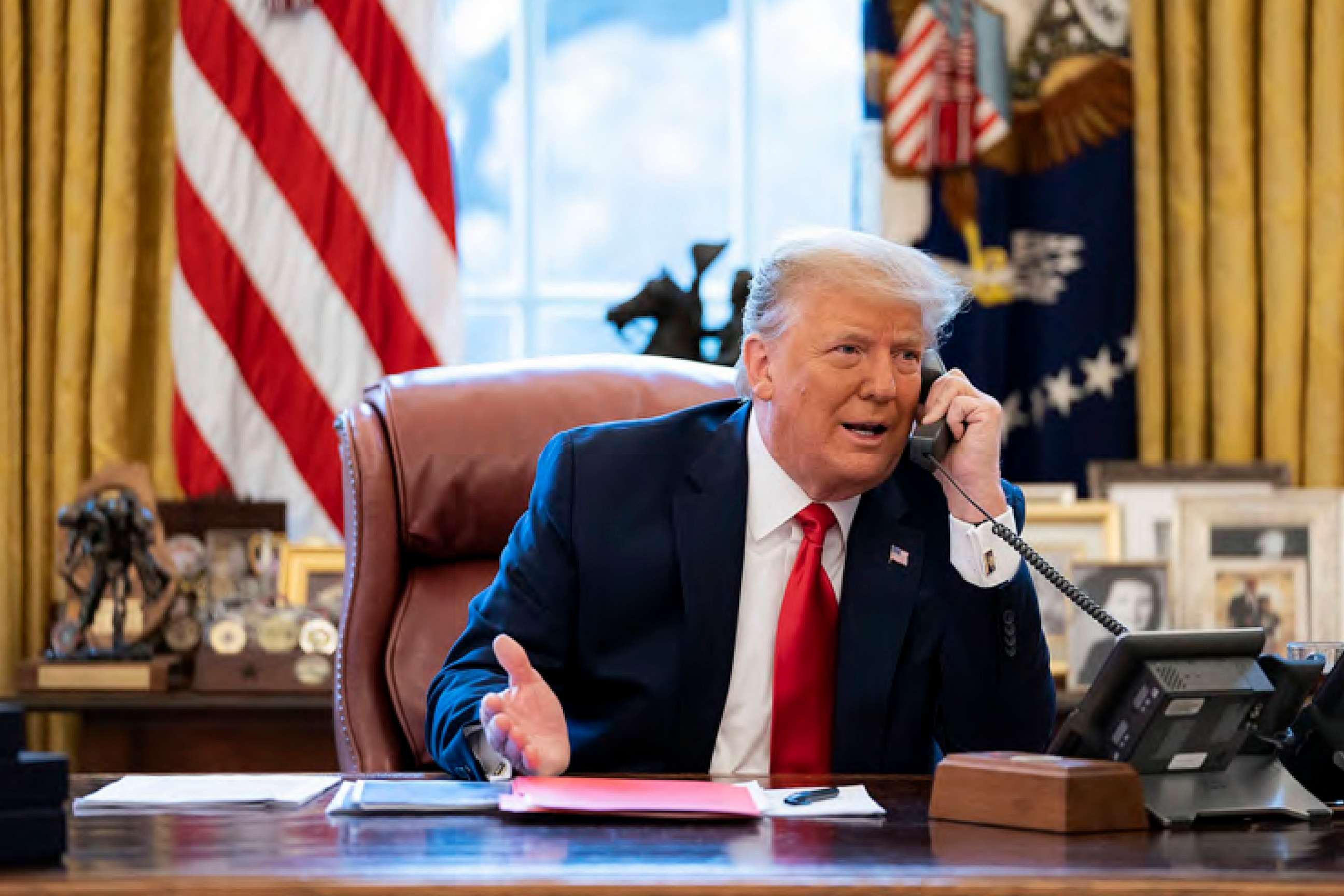 PHOTO: President Donald Trump talks on the phone to Vice President Mike Pence from the Oval Office of the White House on the morning of Jan. 6, 2021.