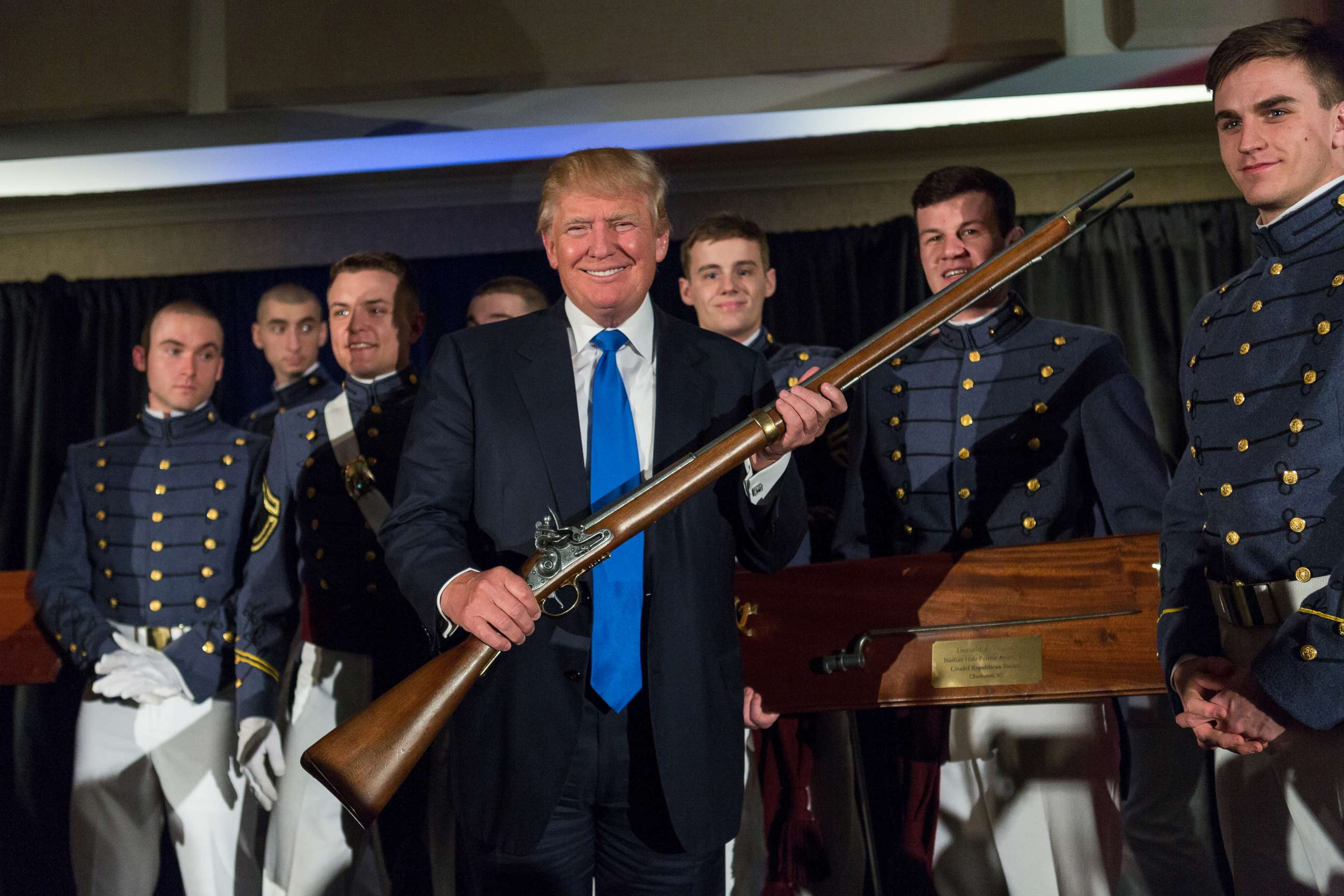 PHOTO: Reality TV host and New York real estate mogul Donald Trump holds up a replica flintlock rifle awarded him by cadets during the Republican Society Patriot Dinner at the Citadel Military College, Feb. 22, 2015 in Charleston, S.C.