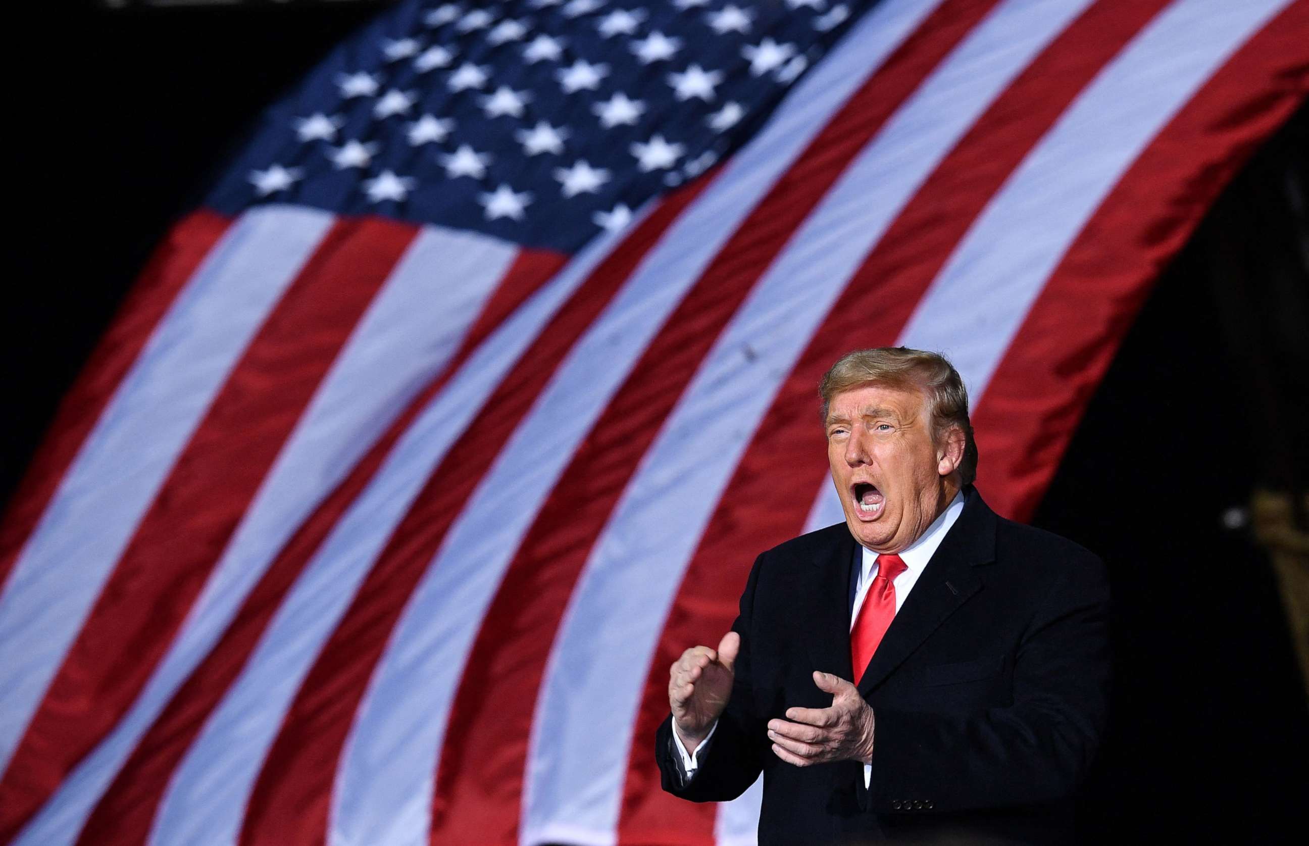 PHOTO: President Donald Trump claps during a rally on Jan. 4, 2021 in support of Republican incumbent senators Kelly Loeffler and David Perdue ahead of Senate runoff in Dalton, Georgia.