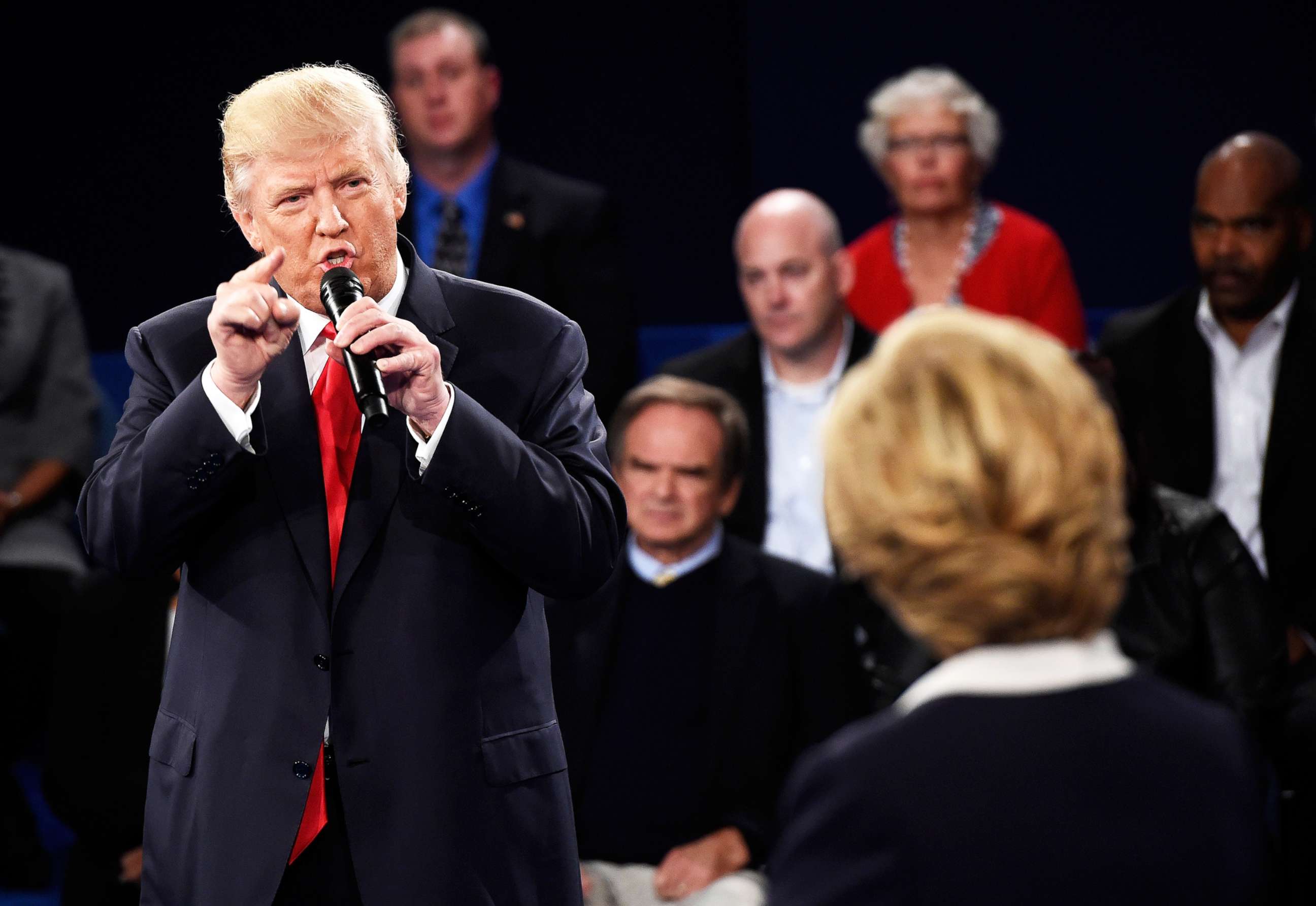 PHOTO: Republican presidential nominee Donald Trump speaks as Democratic presidential nominee former Secretary of State Hillary Clinton looks on during the town hall debate on Oct. 9, 2016, in St Louis.
