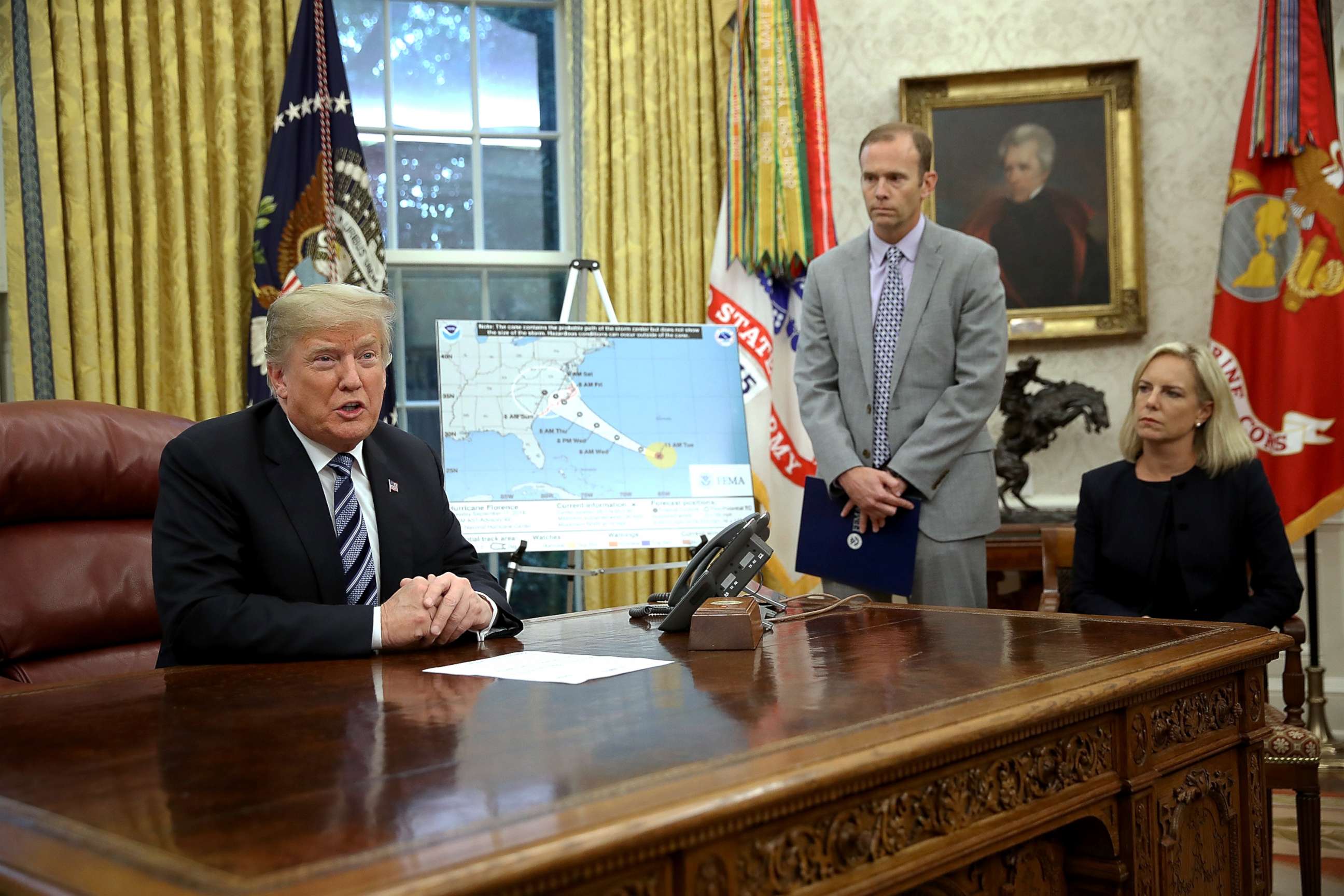 PHOTO: President Donald Trump speaks while meeting with FEMA Administrator Brock Long (C) and Homeland Security Secretary Kirstjen Nielsen in the Oval Office on Sept. 11, 201,8 in Washington, D.C.
