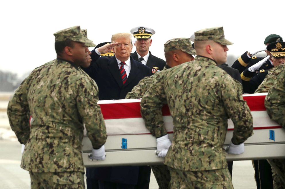 PHOTO: President Donald Trump salutes as a military carry team moves the transfer case containing the remains of Scott A. Wirtz during a dignified transfer at Dover Air Force Base in Dover, Del., Jan 19, 2019.