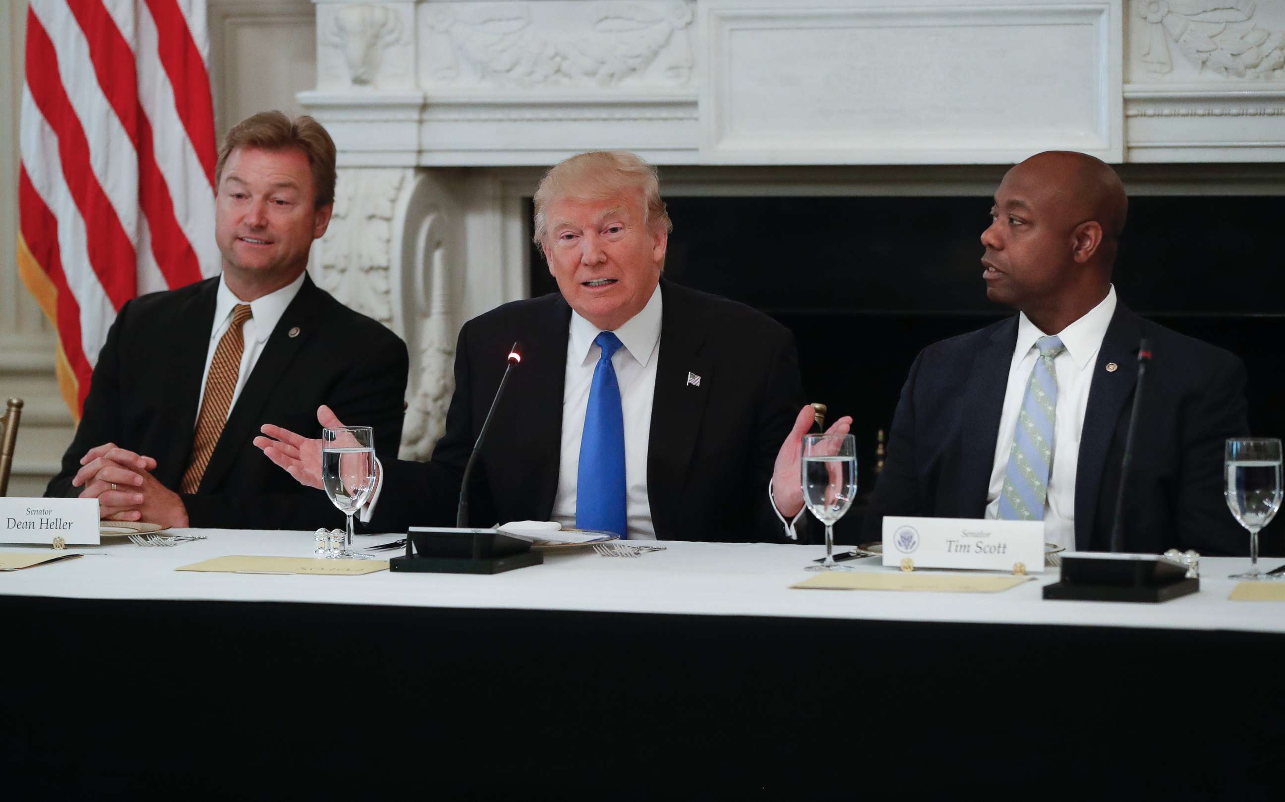 PHOTO: President Donald Trump, flanked by Sen. Dean Heller, R-Nev., left, and Sen. Tim Scott, R-S.C.,speaks at a luncheon with GOP leadership, July 19, 2017, in the State Dining Room of the White House in Washington. 