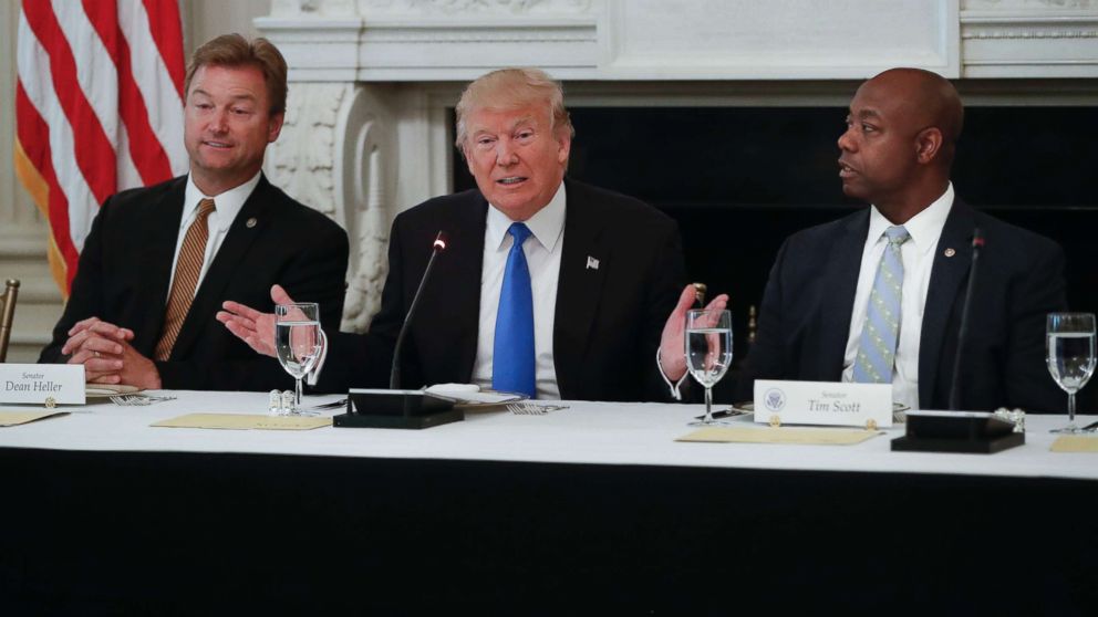 PHOTO: President Donald Trump, flanked by Sen. Dean Heller, R-Nev., left, and Sen. Tim Scott, R-S.C.,speaks at a luncheon with GOP leadership, July 19, 2017, in the State Dining Room of the White House in Washington. 