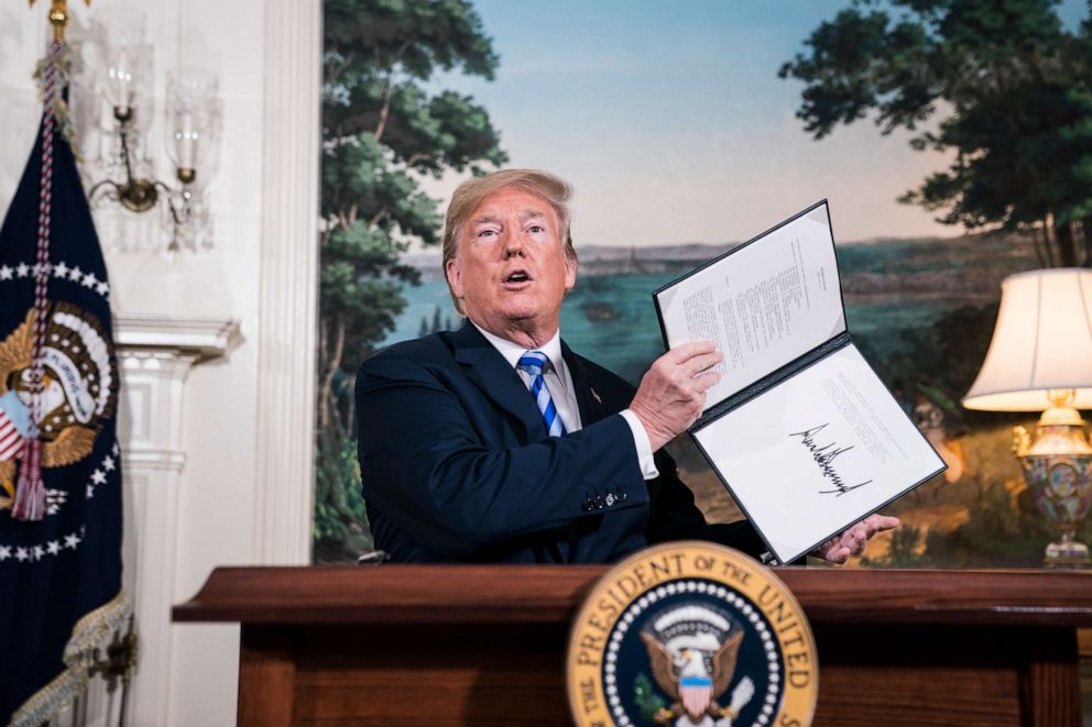PHOTO: President Donald Trump signs a National Security Presidential Memorandum as he announces the withdrawal of the United States from the Iran nuclear deal from the Diplomatic Reception Room of the White House, May 08, 2018 in Washington.