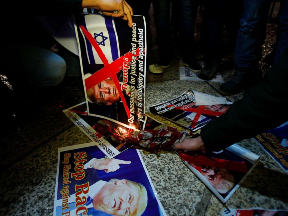 PHOTO: Demonstrators burn posters of President Trump in Bethlehems Manger Square in protest over Trumps declaration of Jerusalem as Israels capital on Dec. 6, 2017.