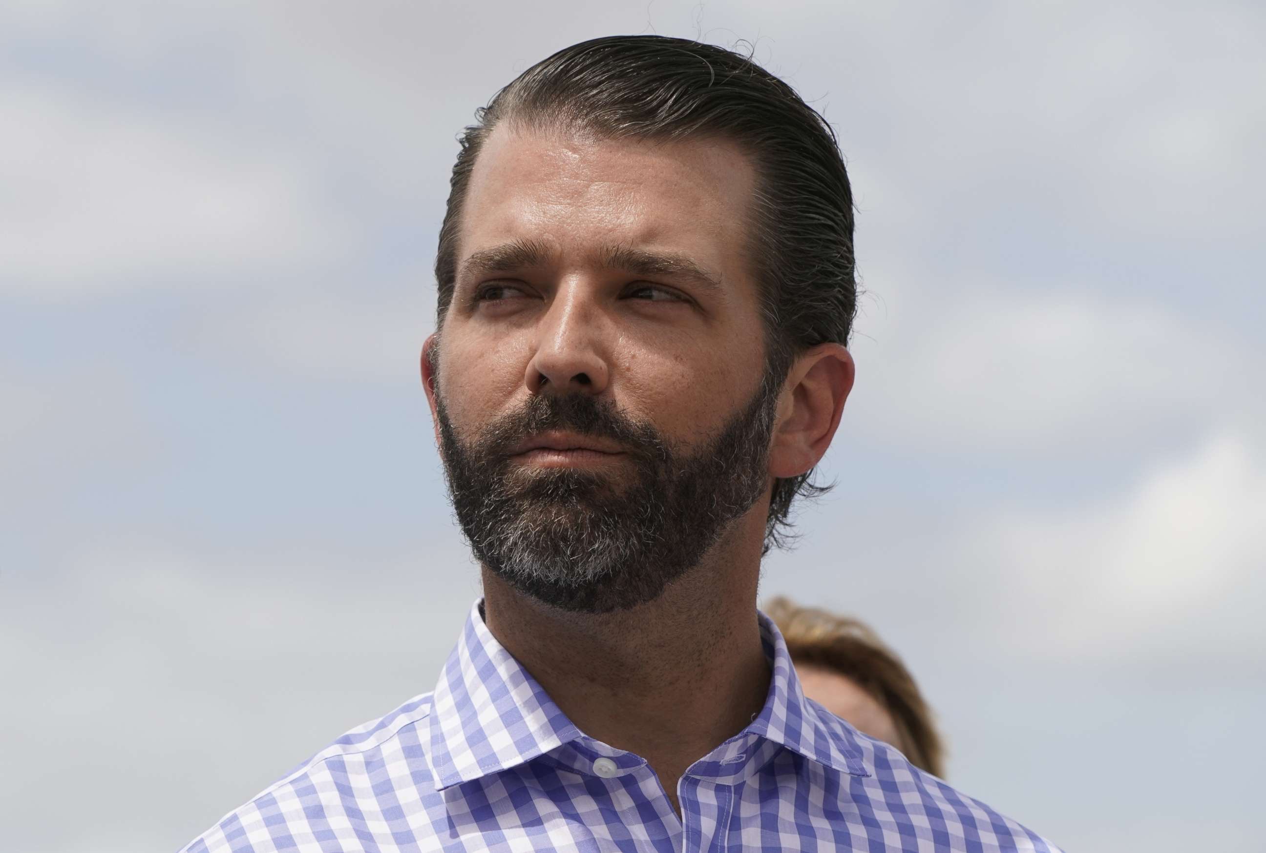 PHOTO: Donald Trump Jr. listens to his father, President Donald Trump, speak during a visit to Lake Okechobee and the Herbert Hoover Dike in Canal Point, Fla., March 29, 2019.