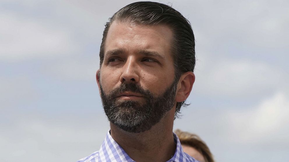 PHOTO: Donald Trump Jr. listens to his father, President Donald Trump, speak during a visit to Lake Okechobee and the Herbert Hoover Dike in Canal Point, Fla.,  March 29, 2019.