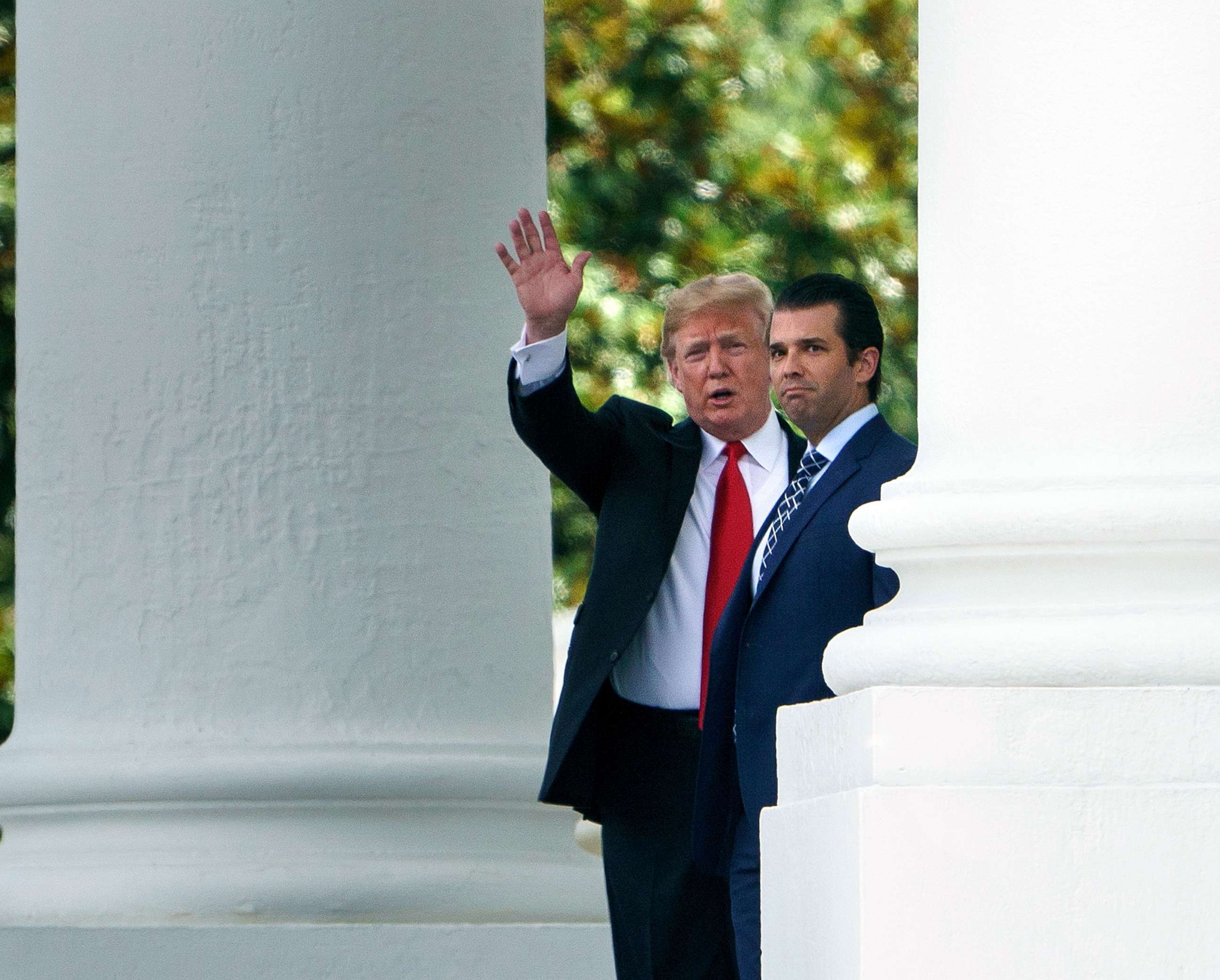 PHOTO: President Donald Trump (L) and his son Donald Trump, Jr., walk to a motorcade from the North Portico of the White House on July 5, 2018 in Washington, D.C.