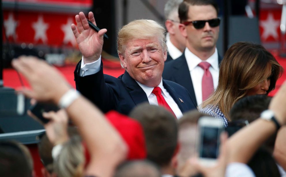 PHOTO: President Donald Trump, accompanied by first lady Melania Trump, waves as he greets military families during an afternoon picnic on the South Lawn of the White House, July 4, 2018, in Washington.