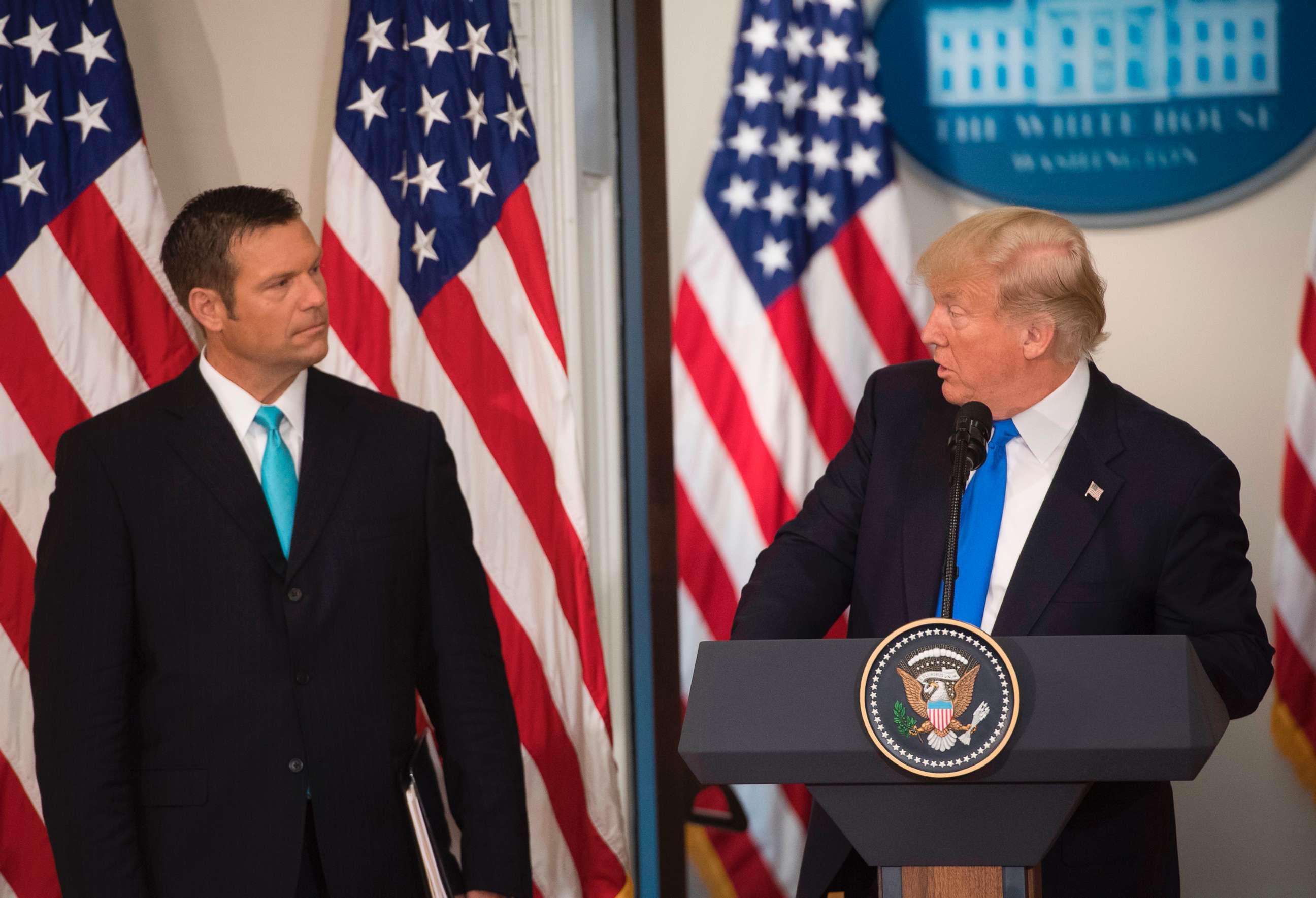 PHOTO: President Donald Trump speaks alongside Kansas Secretary of State Kris Kobach (L) during the first meeting of the Presidential Advisory Commission on Election Integrity in the Eisenhower Executive Office Building in Washington, D.C., July 19, 2017.