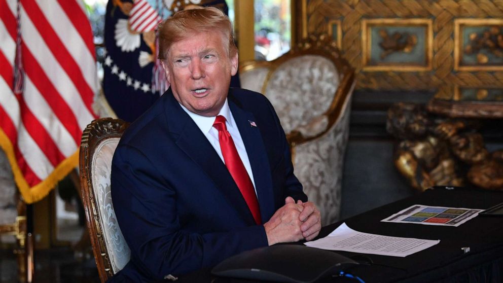 PHOTO: President Donald Trump answers questions from reporters after making a video call to the troops stationed worldwide at the Mar-a-Lago estate in West Palm Beach, Fla., Dec. 24, 2019.