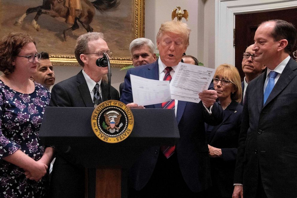 PHOTO: President Donald Trump looks at a medical bill as he speaks during event on ending surprise medical billing at the White House in Washington, D.C., May 9, 2019.