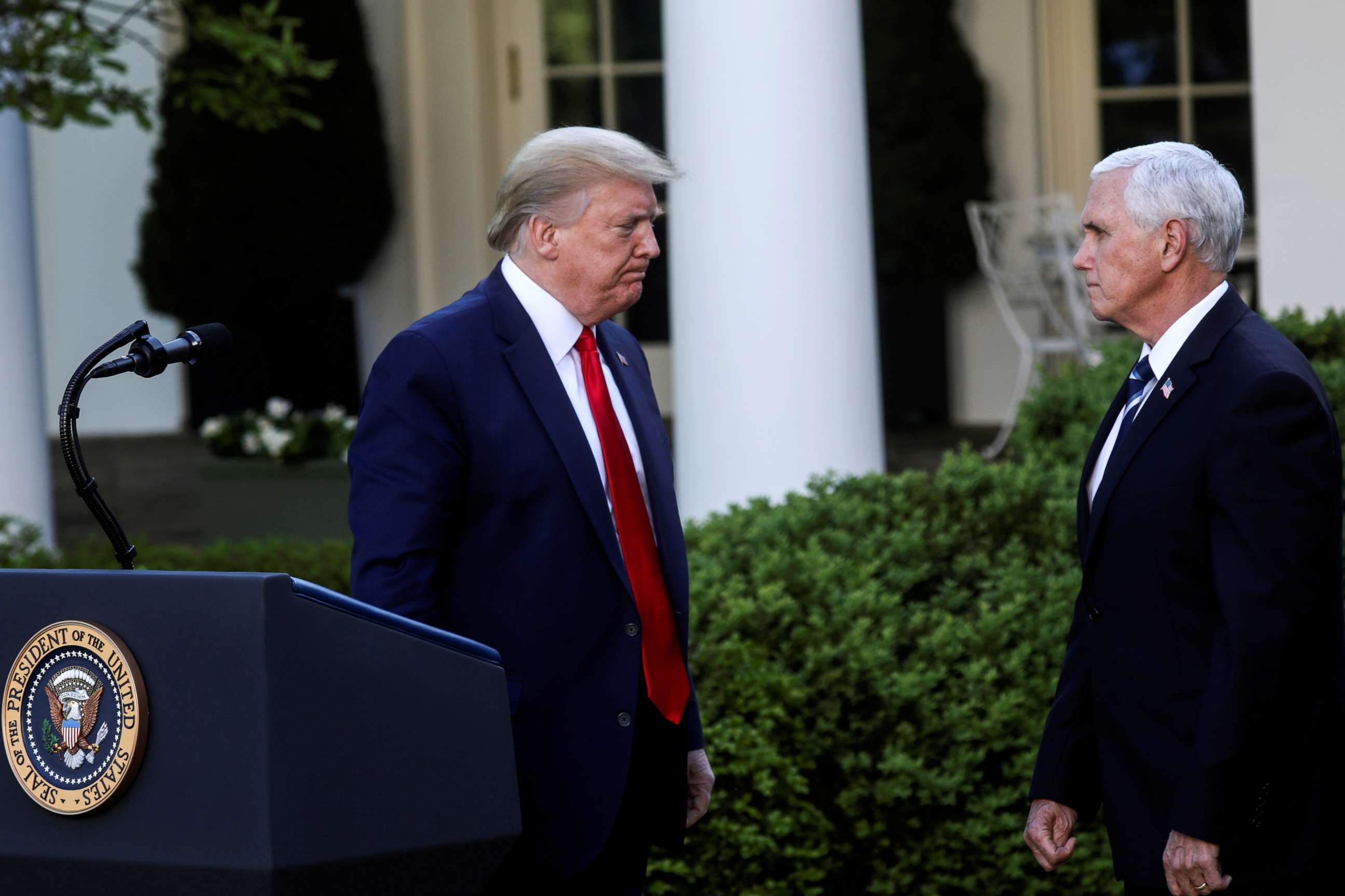 PHOTO: U.S. President Donald Trump turns to Vice President Mike Pence as they depart following a coronavirus response news conference in the Rose Garden at the White House in Washington, D.C., on April 27, 2020.