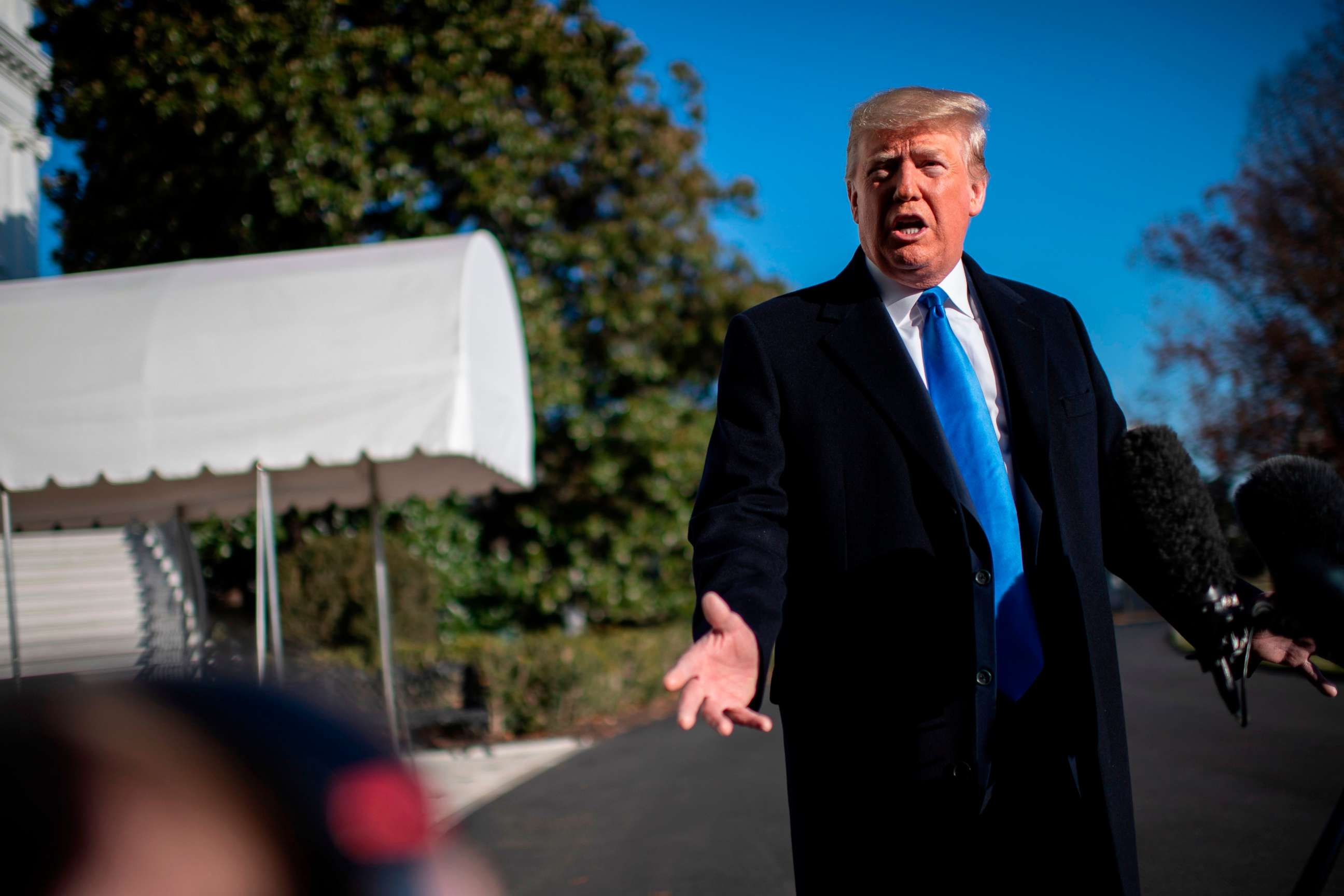 PHOTO: President Donald Trump answers questions from the media before departing the White House on Dec. 7, 2019, in Washington, D.C.