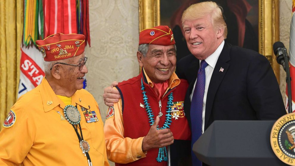 President Donald Trump, right, meets with Navajo Code Talkers Peter MacDonald, center, and Thomas Begay, left, in the Oval Office of the White House in Washington, D.C., Nov. 27, 2017. 