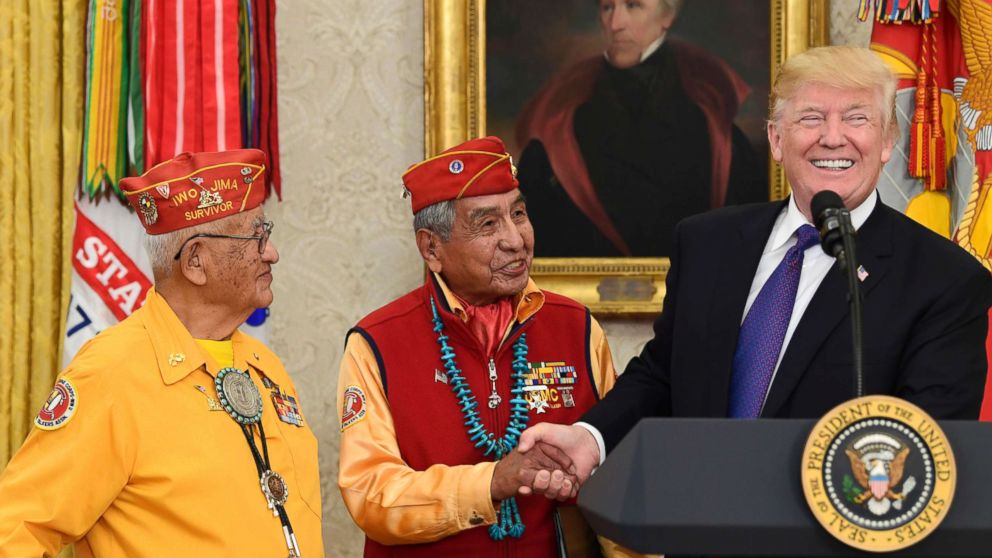 President Donald Trump, right, meets with Navajo Code Talkers Peter MacDonald, center, and Thomas Begay, left, in the Oval Office of the White House in Washington, Nov. 27, 2017. 