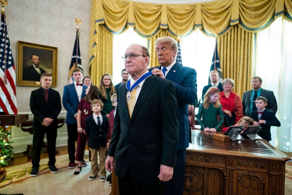 PHOTO: President Donald Trump presents the Presidential Medal of Freedom to Dan Gable in the Oval Office on Dec. 07, 2020, in Washington.