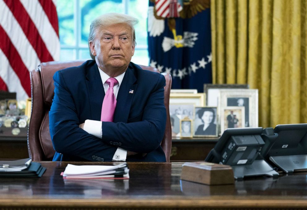 PHOTO: President Donald Trump talks to reporters in the Oval Office at the White House, July 20, 2020, in Washington.