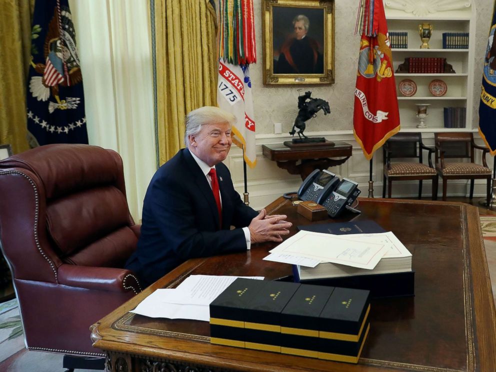 PHOTO: President Donald Trump talks with journalists before signing tax reform legislation into law in the Oval Office Dec. 22, 2017 in Washington.