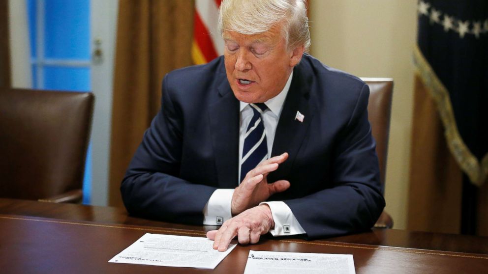 PHOTO: President Donald Trump reads from prepared remarks as he speaks about his summit meeting in Finland with Russian President Vladimir Putin at the start of a meeting with members of Congress at the White House in Washington, July 17, 2018.